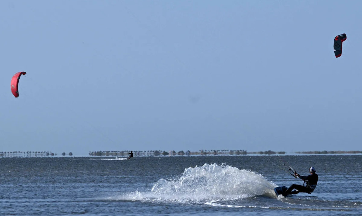 Tourists ride while taking part in kitesurfing in Tunisia’s southern island of Djerba on May 5, 2026. (AFP)