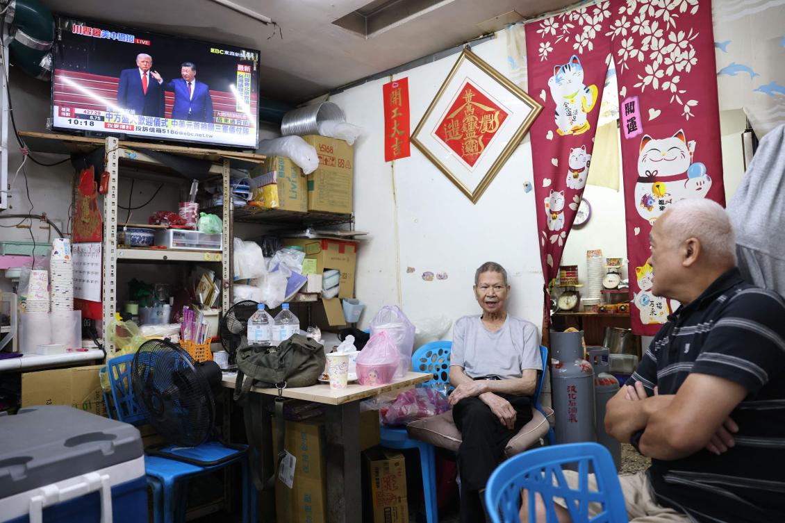 Above, a television news program at a restaurant in Taipei on May 14, 2026 shows the meeting between the US President Donald Trump and China’s President Xi Jinping in Beijing. (AFP)