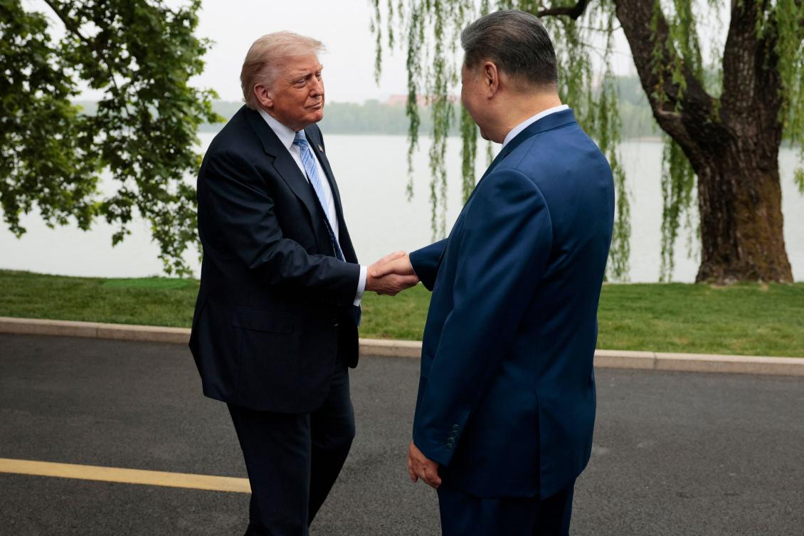 US President Donald Trump (L) is greeted by Chinese President Xi Jinping at Zhongnanhai Garden in Beijing on May 15, 2026. (AFP)