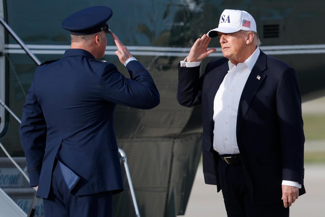 President Donald Trump, right, salutes Air Force Col. Christopher M. Robinson, commander of the 89th Airlift Wing, left, before boarding Marine One upon his arrival at Joint Base Andrews, Md., Friday, May 15, 2026. (AP Photo/Luis M. Alvarez)