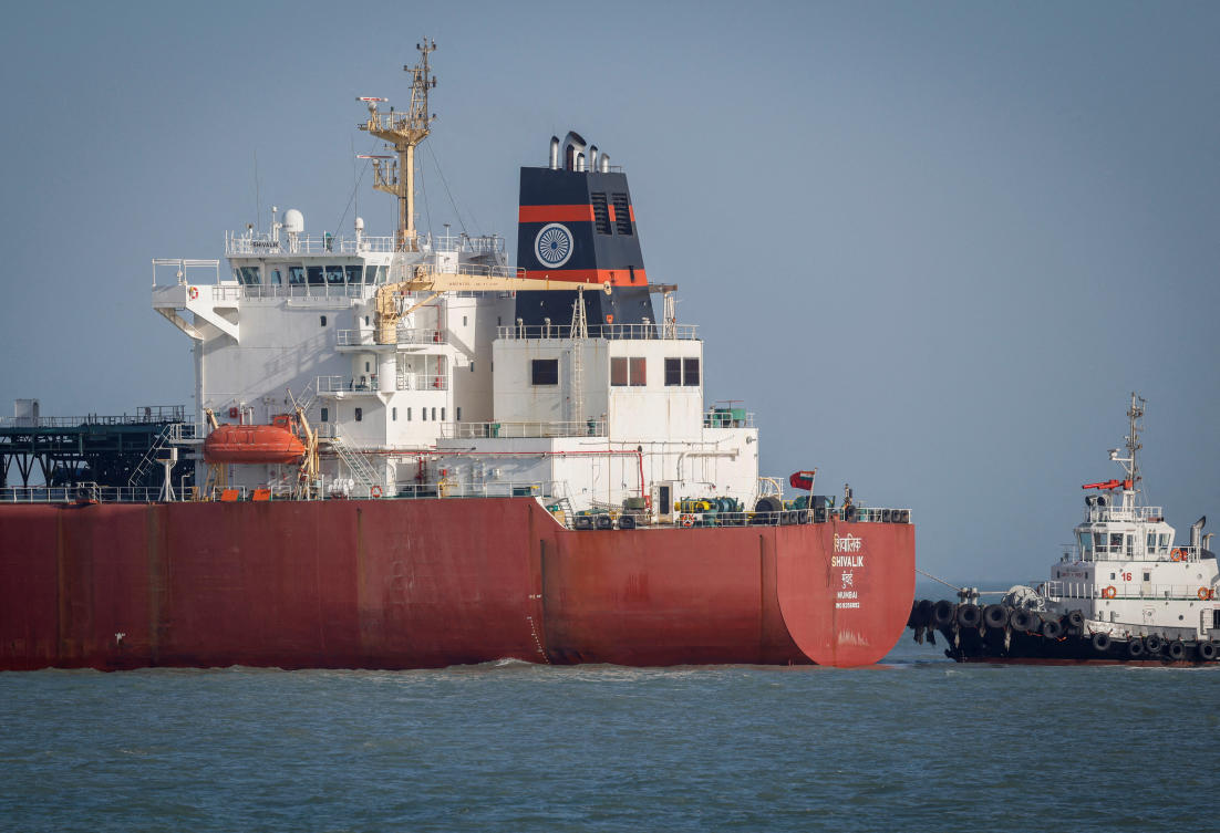 FILE PHOTO: A coastguard boat approaches an Indian liquefied petroleum gas (LPG) carrier, Shivalik, as it arrives at Mundra Port via the Strait of Hormuz, amid the U.S.-Israel conflict with Iran, in Gujarat, India, March 16, 2026. REUTERS/Amit Dave/File Photo