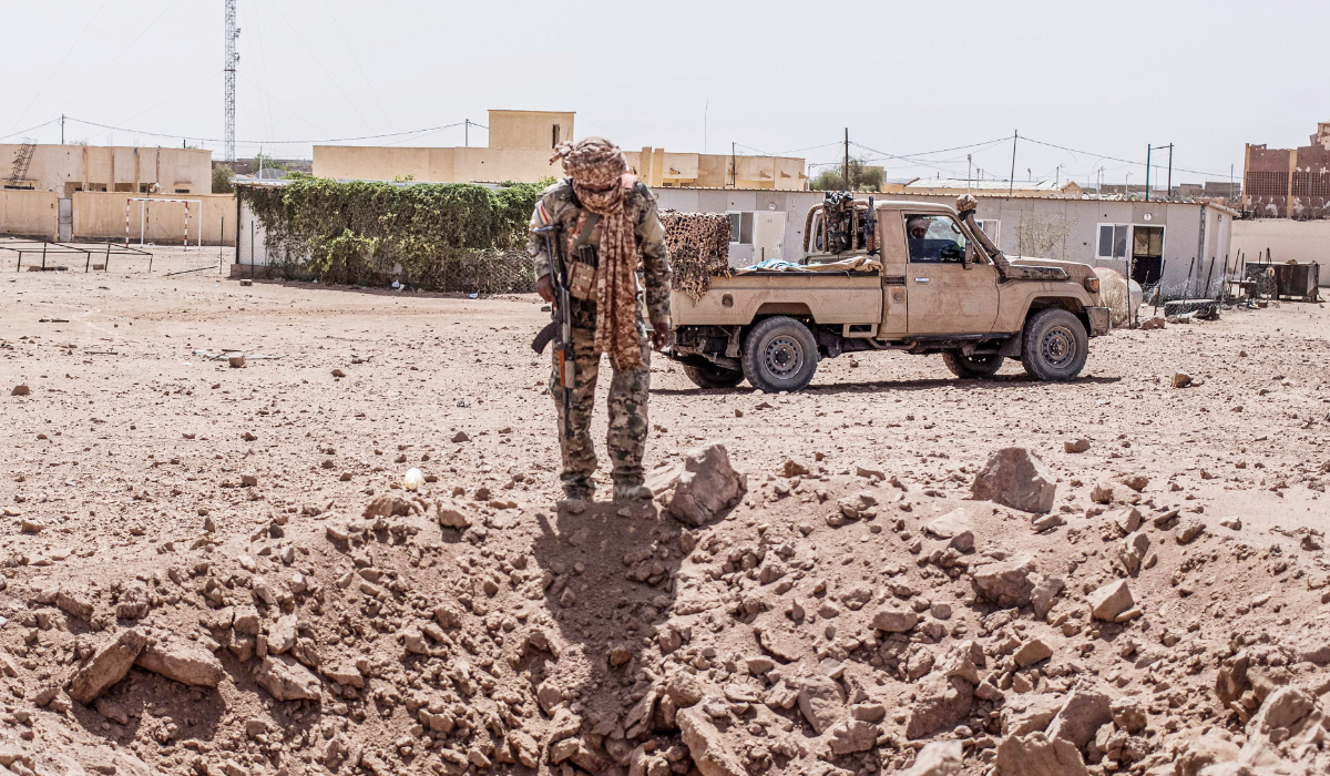 A soldier from the National Front for the Liberation of Azawad (FLA) inspects a crater in Kidal on May 14, 2026 caused by aerial bombardment from Malian Armed Forces (FAMA). (AFP)