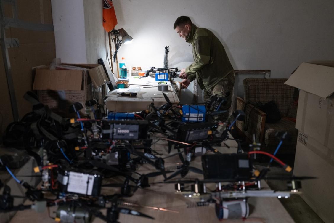 A Ukrainian serviceman prepares FPV drones at an undisclosed location near the frontline on May 7, 2026. (The 93rd Kholodnyi Yar Separate Mechanized Brigade/AFP)