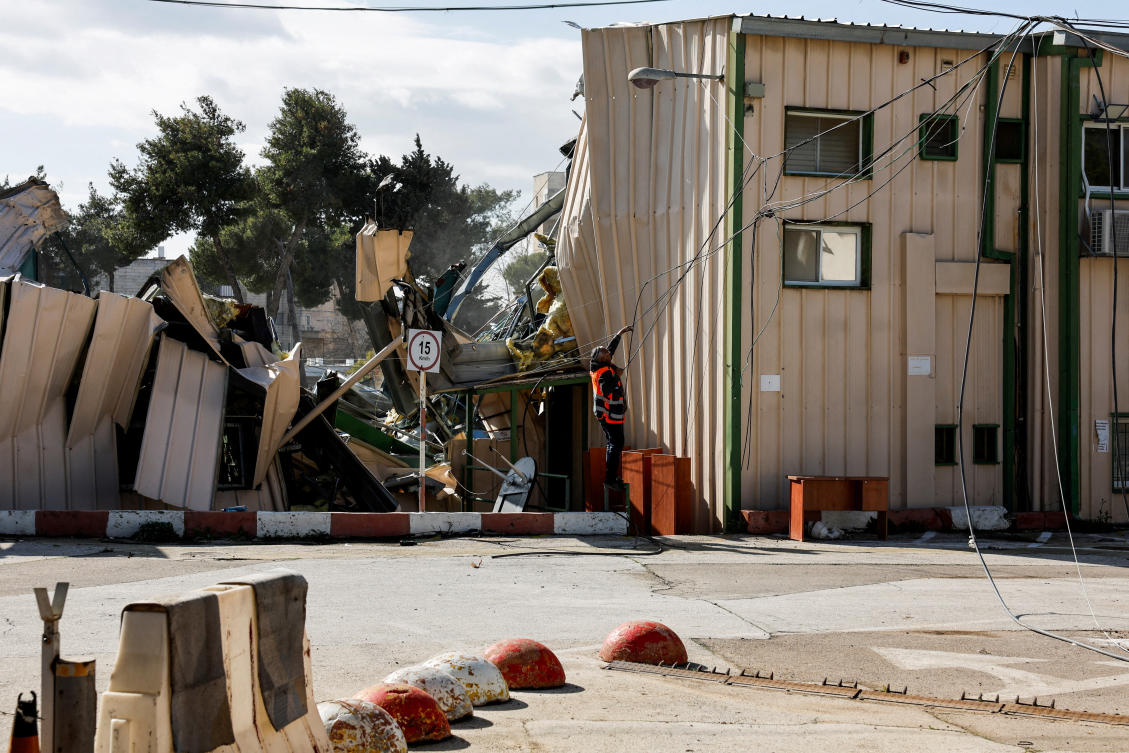 FILE PHOTO: A man handles fallen cables at the Jerusalem headquarters of the United Nations Relief and Works Agency for Palestine Refugees (UNRWA) as the headquarters is dismantled by Israeli forces, in East Jerusalem, January 20, 2026. REUTERS/Ammar Awad/File Photo