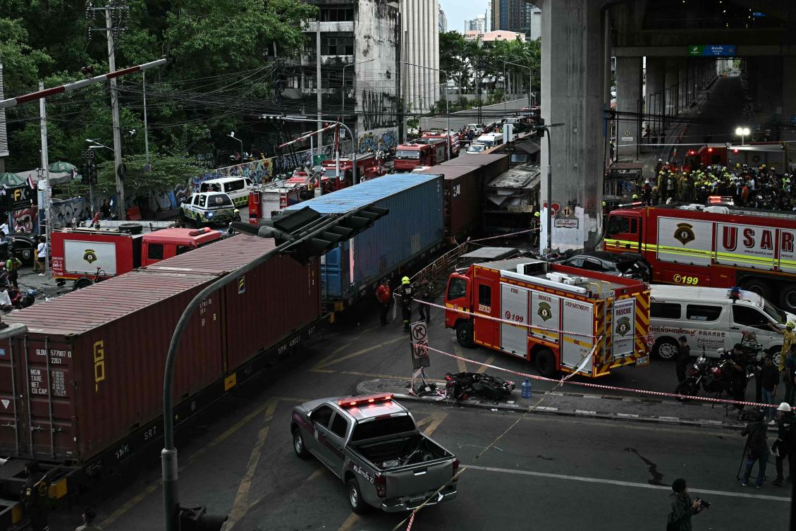 The freight train crashed into the public bus on Saturday afternoon at a busy junction in Bangkok, with the vehicle bursting into flames and 30 people left injured. (AFP)