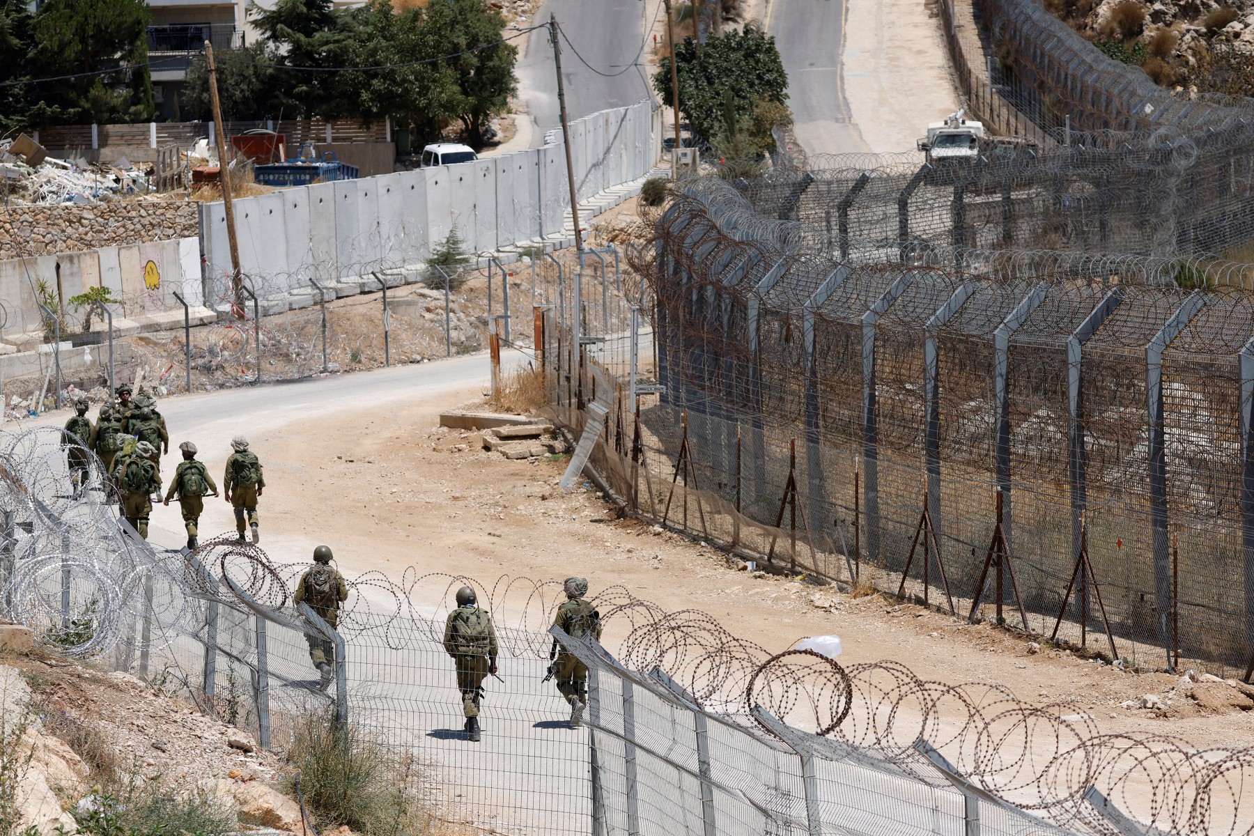 Israeli troops patrol the border fence with Syria in the Israel-annexed Golan Heights on July 23, 2025.