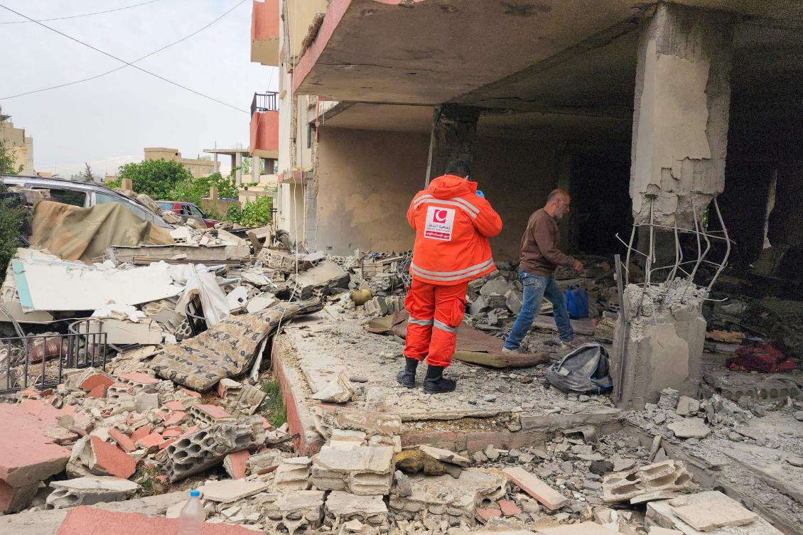 An emergency worker inspects the damage following an Israeli strike on an apartment building in Baalbek on May 18, 2026. (AFP)