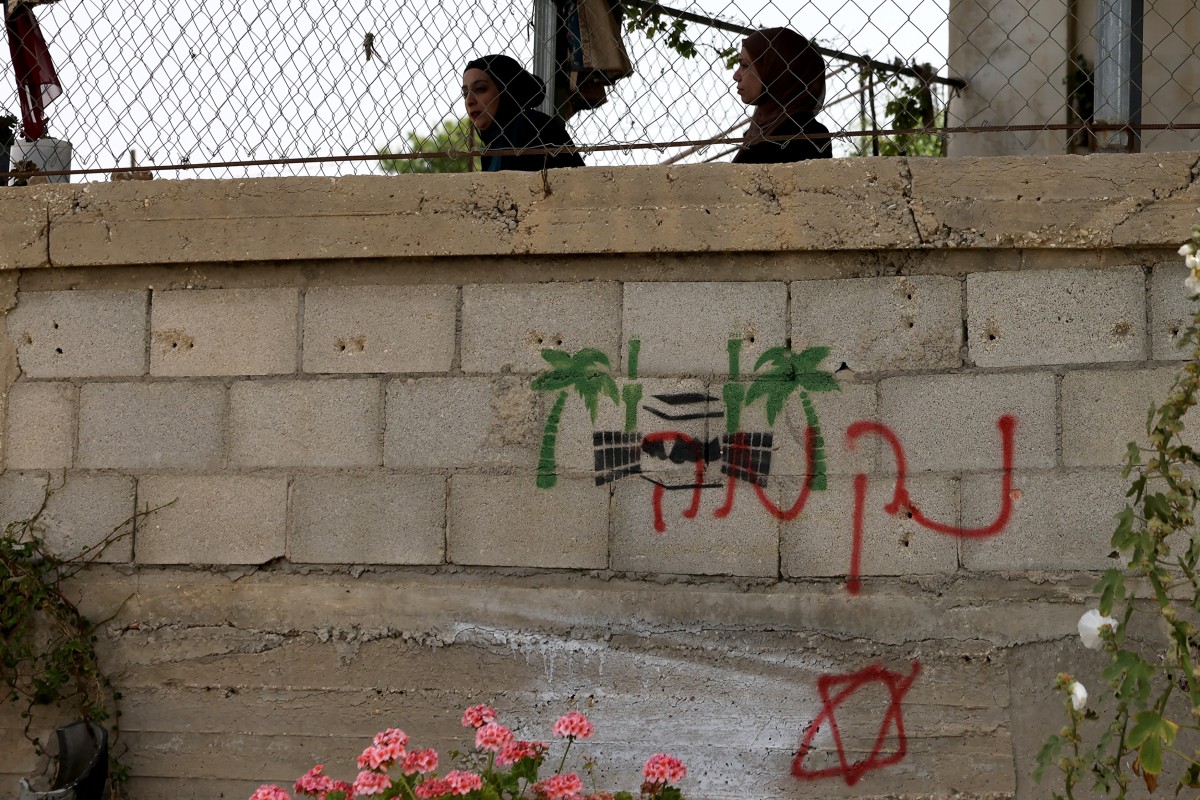 Hebrew graffiti is daubed on the wall of the home of the Palestinian Ghnimat family, allegedly sprayed by Jewish settlers from the nearby Bat Ein settlement, in the village of Surif, near the Israeli-occupied West Bank city of Hebron. (Files/AFP)