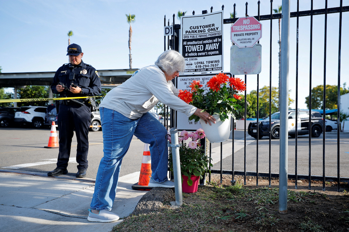 A woman lays flowers outside the Islamic Centre of San Diego, the morning following a fatal shooting. (Reuters)