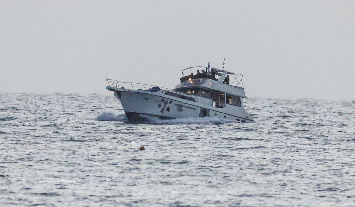 A boat bearing symbols of one of the vessels belonging to the Gaza-bound aid flotilla and intercepted by the Israeli navy, is motored towards the Israeli port of Ashdod, about 40 kilometres south of Tel Aviv, on May 19, 2026. (AFP)