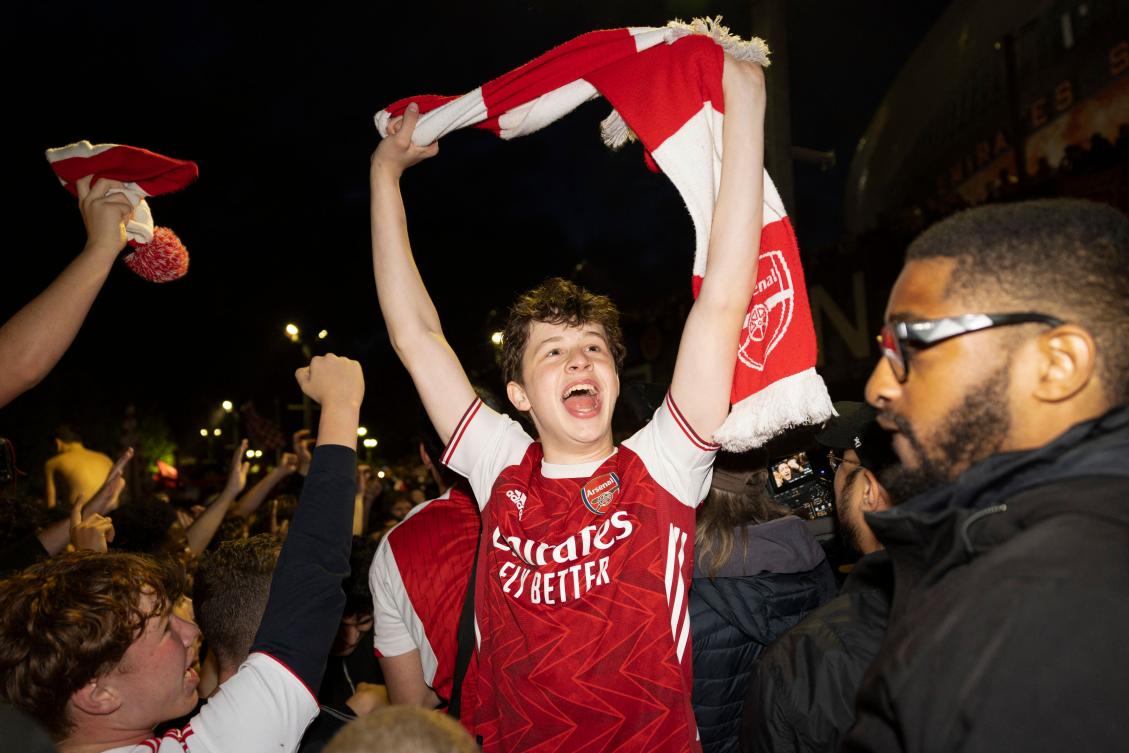 Arsenal fans celebrate their team wining the English Premier League, outside the Emirates Stadium in London on May 19, 2026. (AFP)