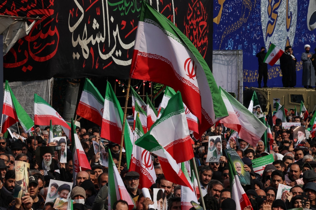 Iranians wave national flags as they attend the funerals of Iran's Revolutionary Guards Corps (IRGC) commanders killed by US and Israeli airstrikes, at Enghelab Square in Tehran, Iran. (AFP)