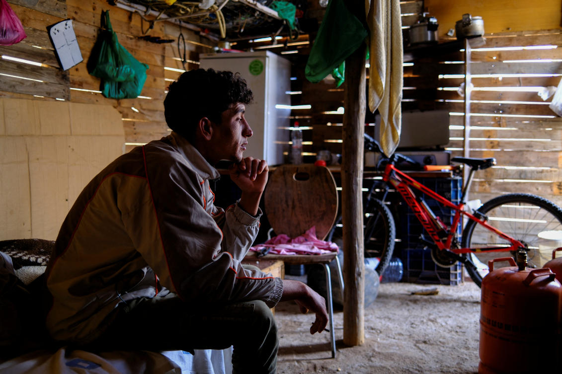 Moroccan migrant Abdelmoujoud Erra, 27, sits on a bed at a shack friend’s near the site where the place they lived burned in a fire in Nijar, province of Almeria Spain. (REUTERS)