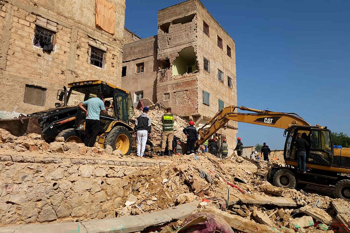 Rescuers search through the rubble of a four-storey building that collapsed overnight in the Moroccan city of Fes, on May 21, 2026. (AFP)
