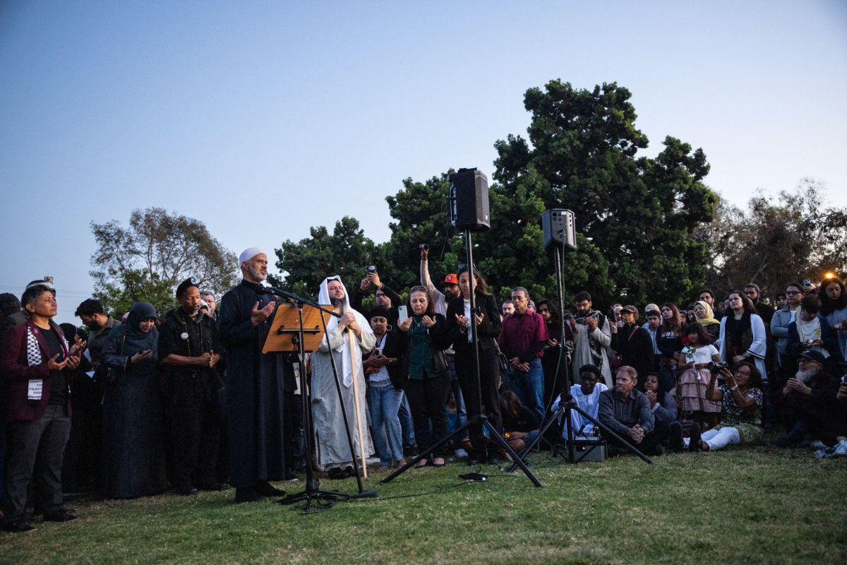 Imam Abdeljalil Mezgouri leads a prayer during a vigil for victims and families of a shooting at the Islamic Center of San Diego, California, on May 19, 2026, a day after the attack. (AFP)