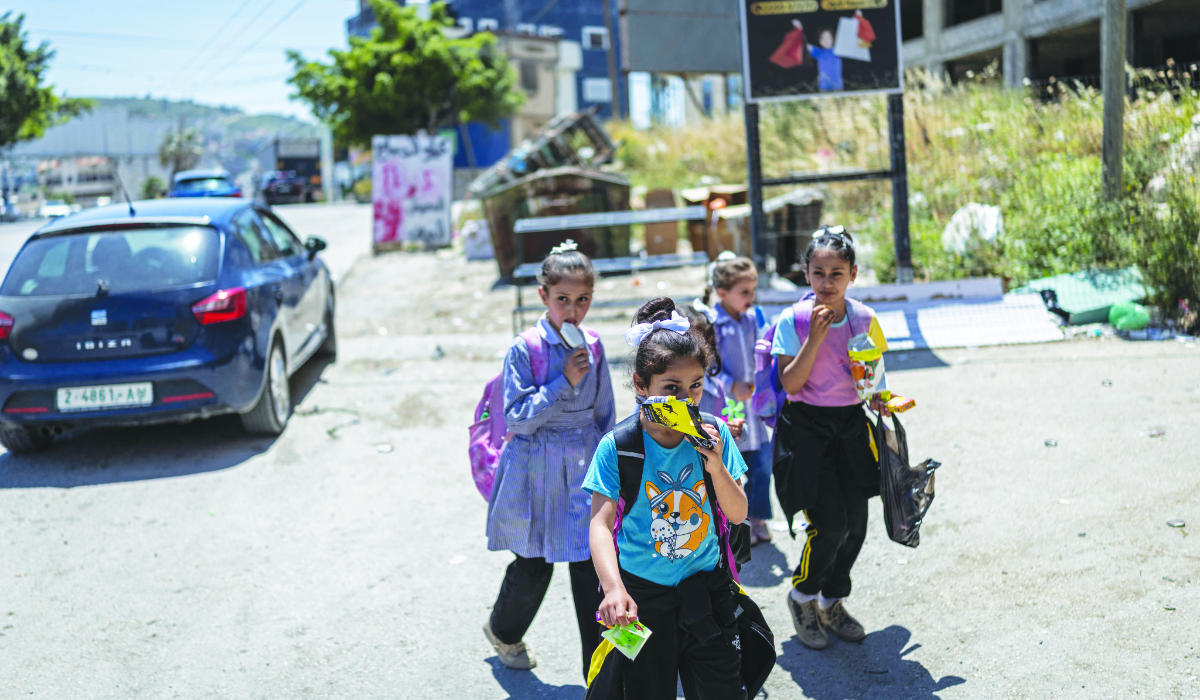 Schoolchildren walk along a street in Silat Al-Dhahr village, south of Jenin in the Israeli-occupied West Bank. (AFP file photo)