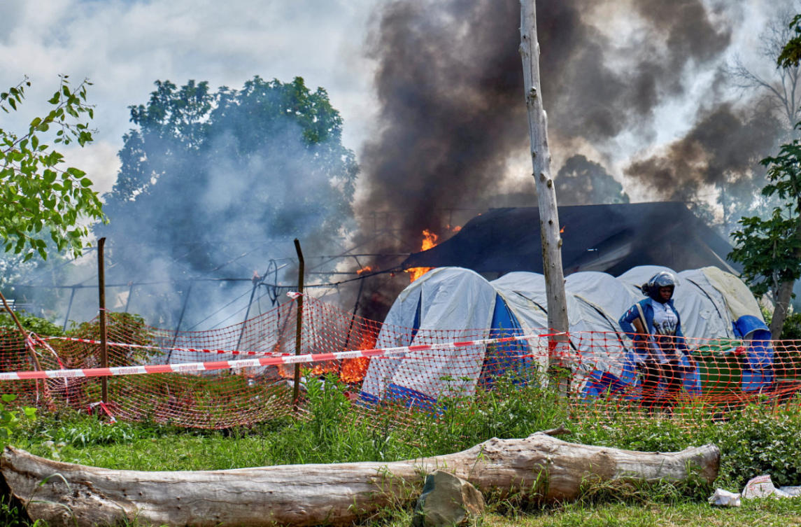 A Congolese police personnel stands guard at the burning Ebola treatment center, as aid agencies intensify efforts to contain a new Ebola outbreak involving the Bundibugyo strain outbreak, in Rwampara general hospital in Rwampara outside Bunia, Ituri province, DR Congo, on May 21, 2026. (Reuters)