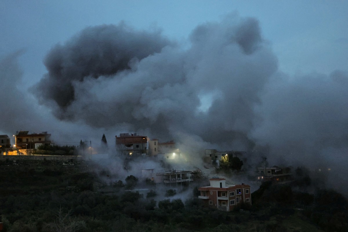 Smoke and sparks ascend from the site of an Israeli airstrike that targeted a building in the southern Lebanese village of Al-Kfour. (AFP)