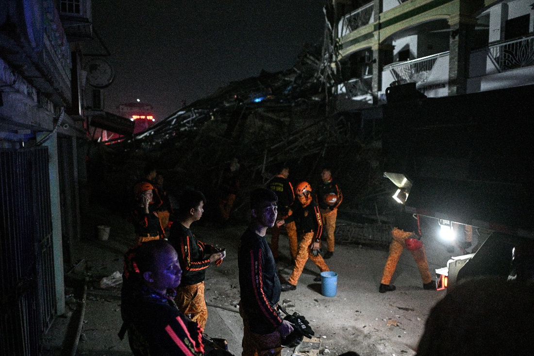 Rescue workers work next to debris after a nine-story building under construction collapsed in Balibago, Angeles City, Philippines. (Reuters)