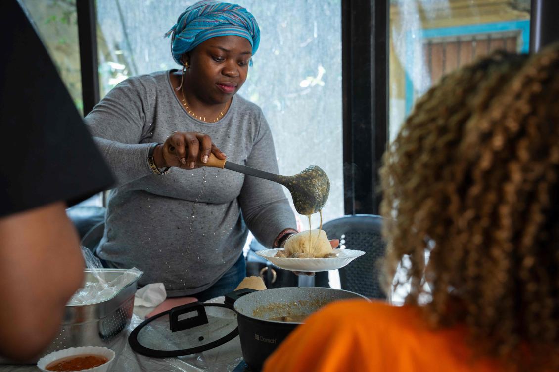 A volunteer serves food at REMAN, an organization supporting migrant workers, in Beirut on May 10, 2026. (AFP)