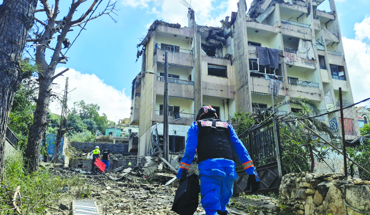 Lebanese rescue workers walk toward the site of Monday's Israeli air raid on the town of Nabatieh, southern Lebanon. (AFP)