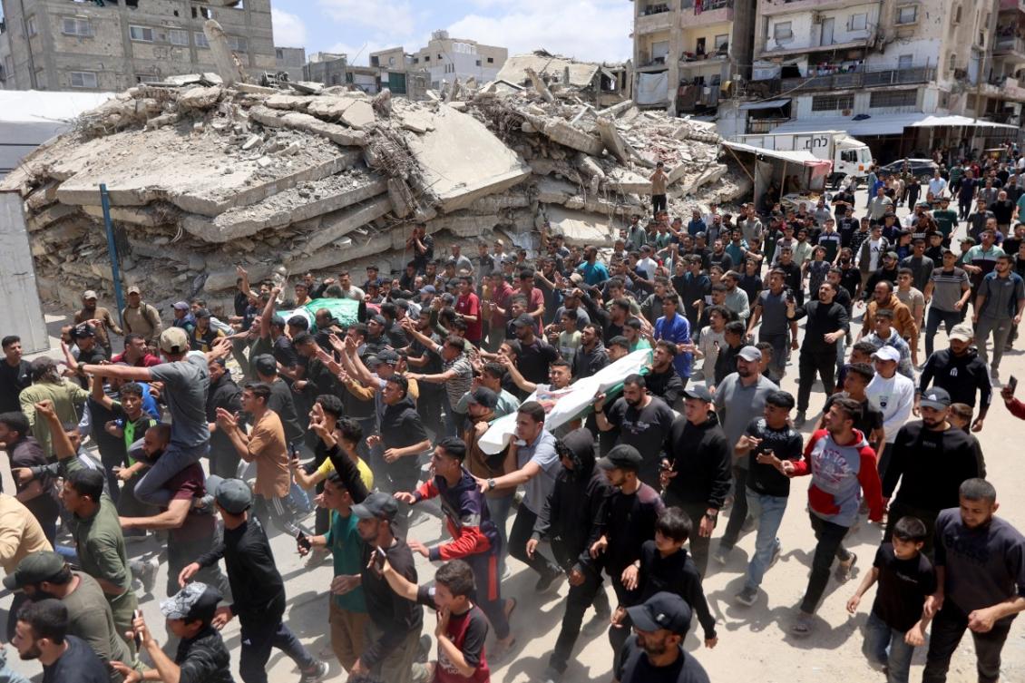 Palestinian mourners carry the bodies of Ezzedine Al-Haddad, the slain chief of the Qassam Brigades - the armed wing of Palestinian movement Hamas, his wife and daughter, all killed in an overnight Israeli strike, during their funeral in Gaza City on May 16, 2026. (AFP)