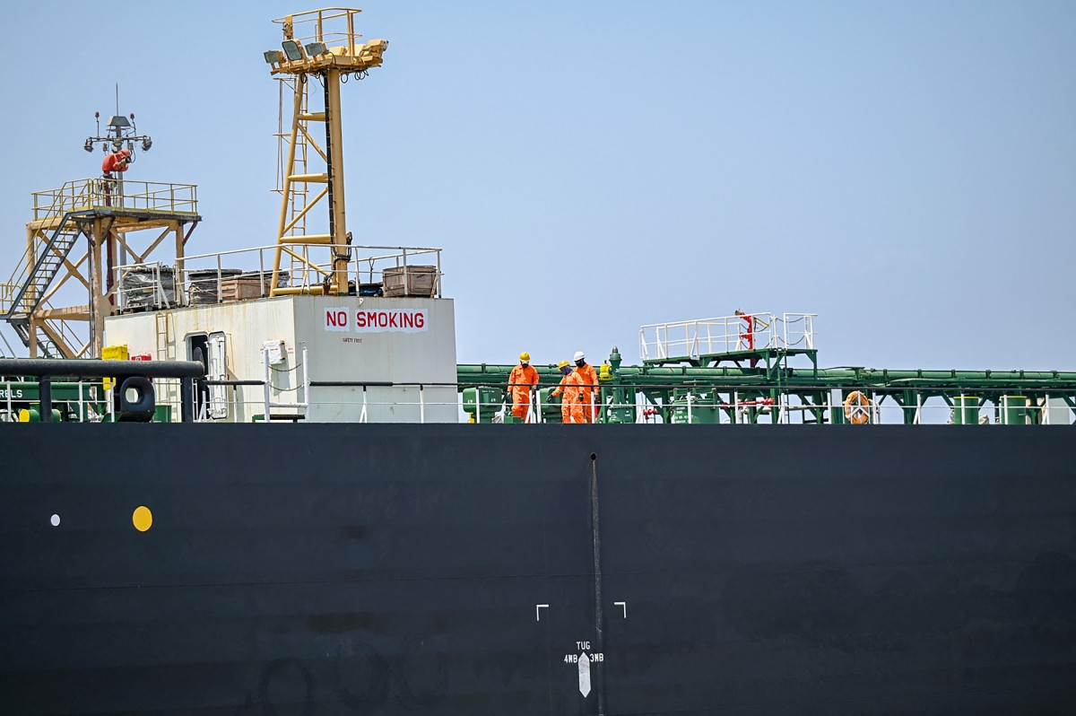 Sailors work on the deck of the Indian-flagged tanker Desh Garima, India. (AFP)