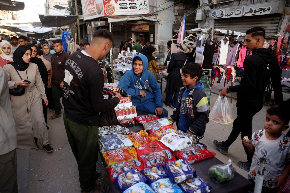 Palestinians shop on the eve of Eid Al-Adha in Khan Younis southern of Gaza Strip on May 26, 2026. (AFP)