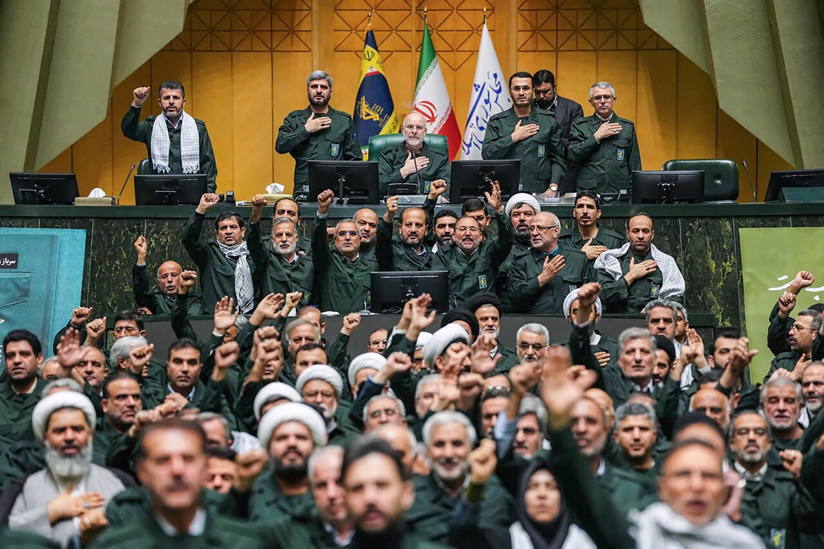 Members of Iran's parliament dressed in IRGC uniforms, chant "Death to America" during a session in Tehran, Iran. (AFP)