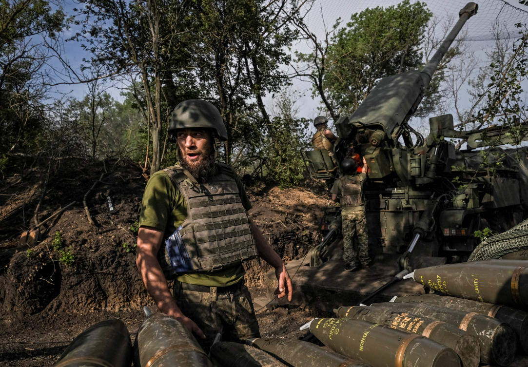 Above, Ukrainian servicemen prepare to fire a Ukrainian self-propelled howitzer 2S22 Bohdana toward Russian positions on a frontline in Zaporizhzhia region on May 25, 2026. (Reuters)