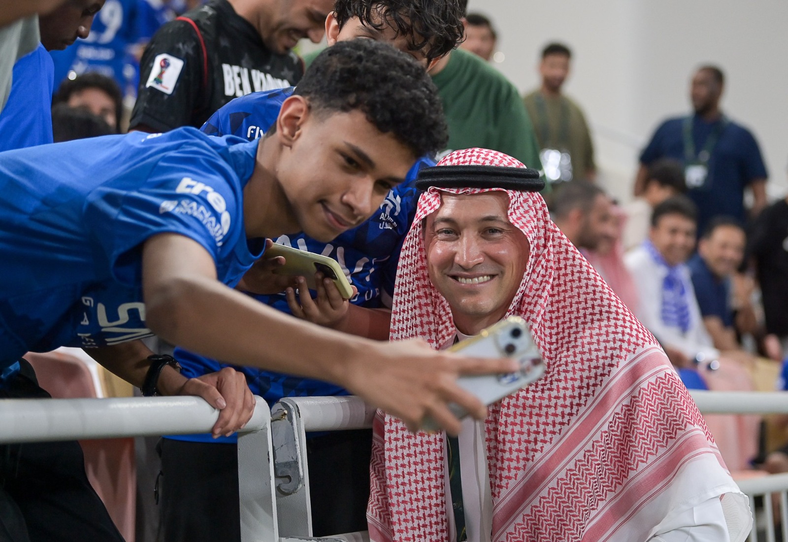 Ben Harburg, in Saudi national attire, poses for a photo with a young Al-Kholood fan earlier in the season. (Al-Kholood Football Club)