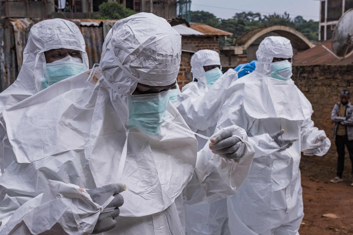 Workers from the Uganda Red Cross Society don protective suits as they prepare to evacuate the body of a suspected Ebola victim in Kampala on May 26, 2026. (AFP)