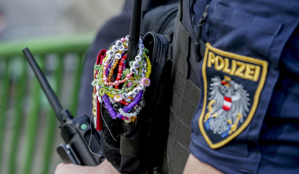 A police officer is decorated with Taylor Swift bracelets while guarding the city center in Vienna on Aug. 8, 2024. (AP)