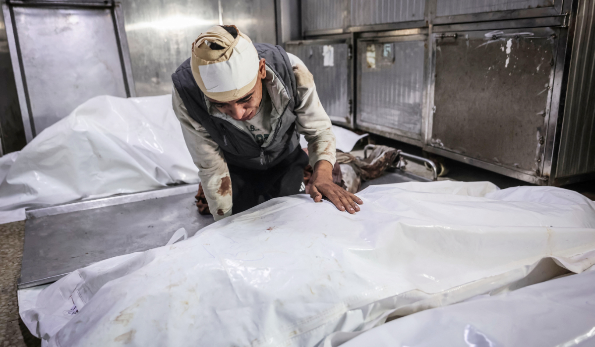 Mohammed Al-Shawish mourns over the body of his wife Shaima Al-Shawish, who was killed in an Israeli strike, in Gaza City on May 28, 2026. (AFP)
