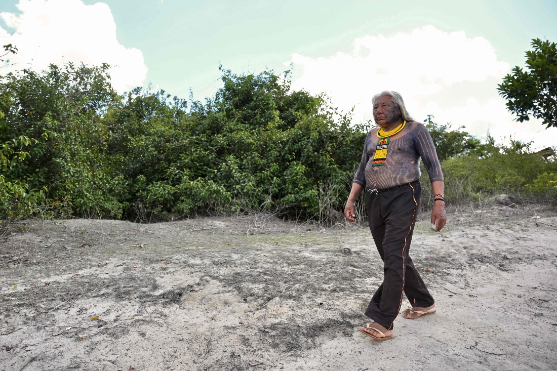 Brazilian Indigenous chief Megaron Txucarramae, of the Kayapo ethnic group, walks in the village of Pykany, in Menkragnoti Indigenous Territory, southwest of Para State, Brazil. (AFP)