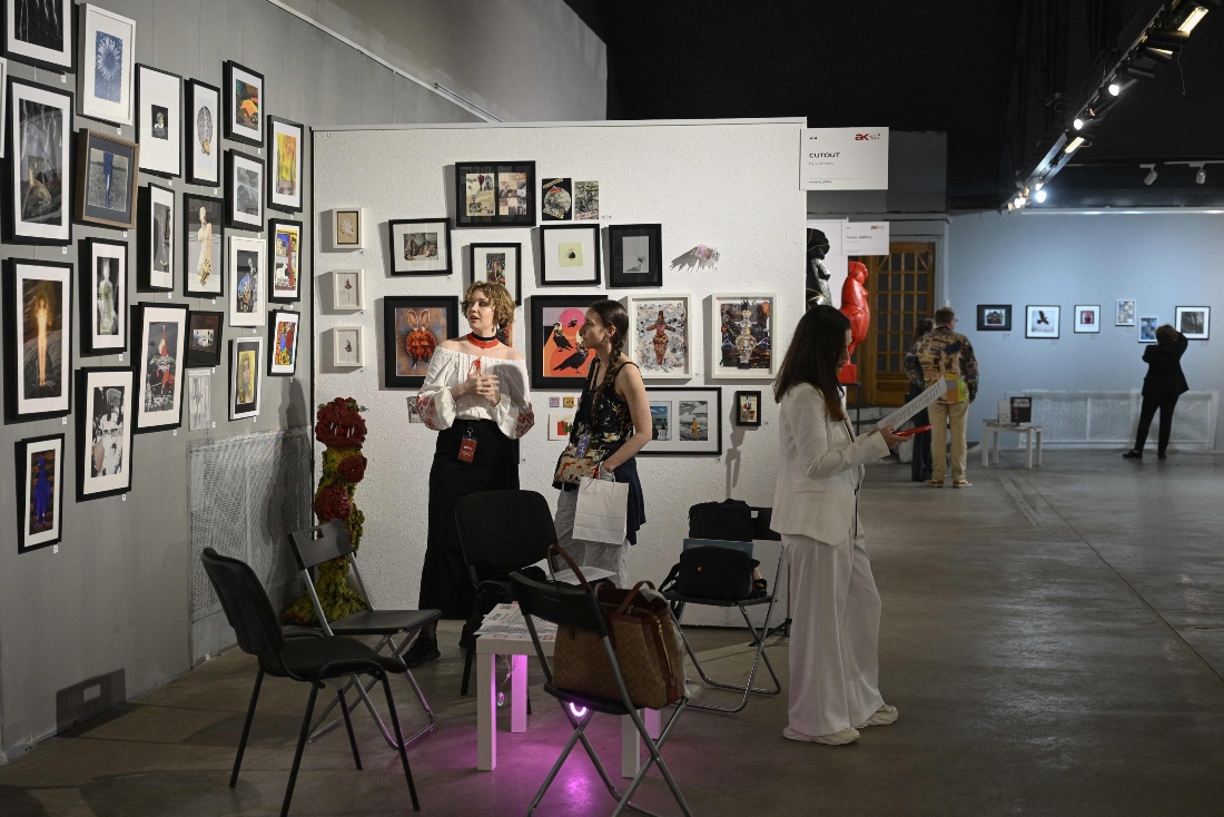 Visitors view an exhibition at the contemporary Art Kyiv fair in Kyiv, Ukraine. (AFP)