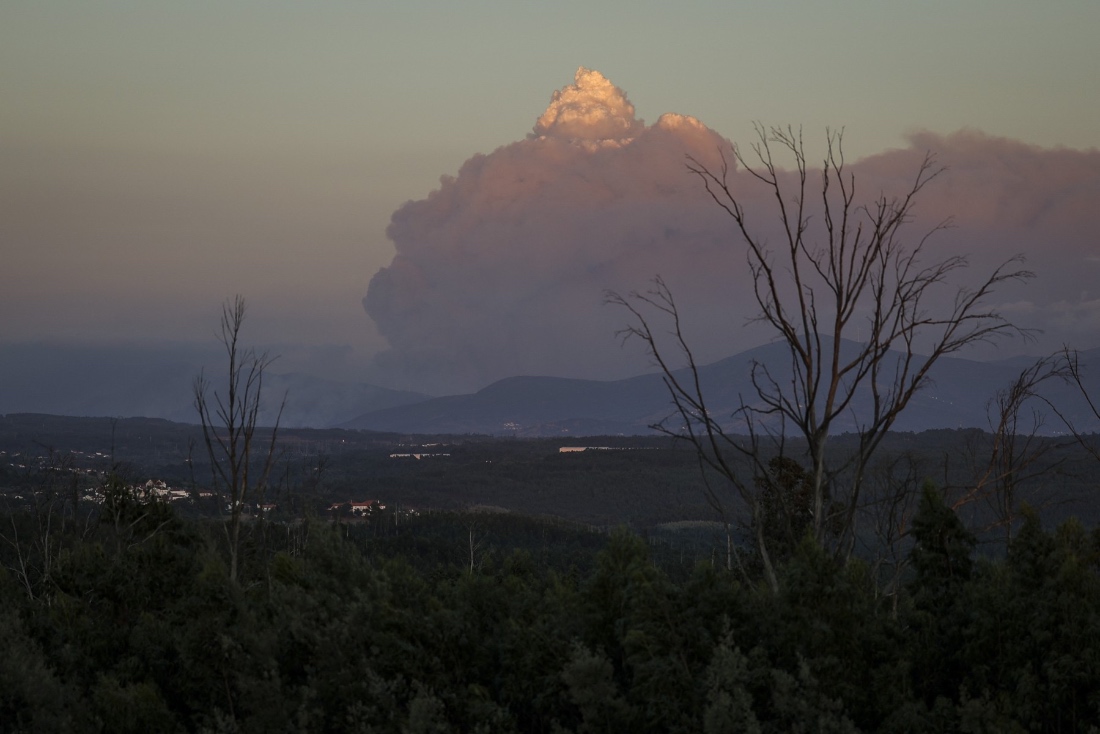 A cloud of smoke coming from the Arganil wildfire is pictured at Ovoa village in Santa Comba Dao, Portugal. (AFP)