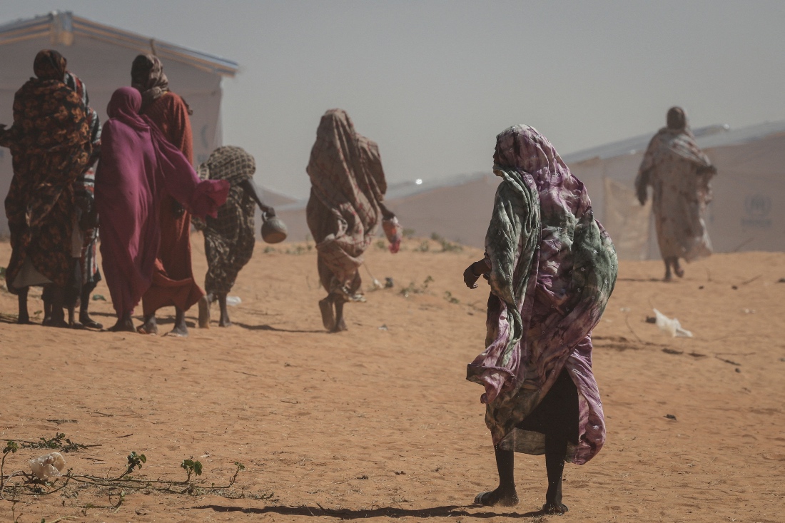Sudanese refugee women walk at the Tulum refugee camp in Chad. (Reuters)