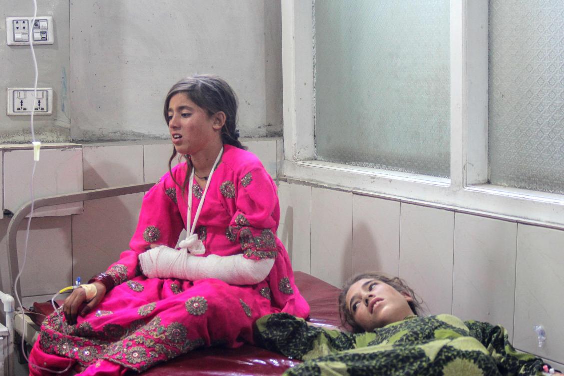 Injured girls receive treatment at a hospital after a truck carrying Afghan families overturned, in Jalalabad on May 30, 2026. A truck overturned in eastern Afghanistan on May 30, killing 18 people on board including 10 children, a provincial official told AFP. (Photo by Aimal Zahir / AFP)