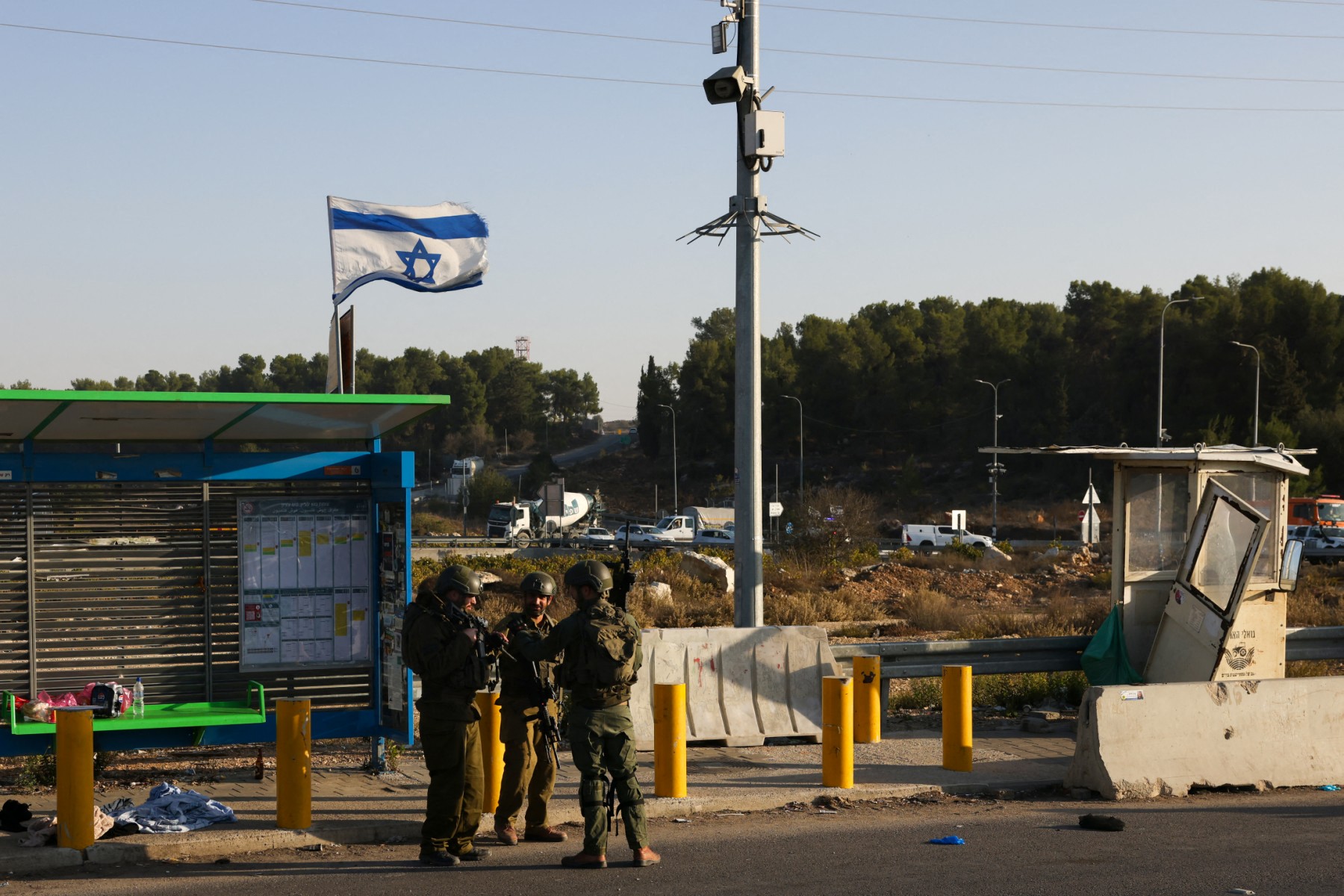 Israeli soldiers stand at the site of a reported attack at the Gush Etzion Junction, in the Israeli-occupied West Bank. (Files/AFP)