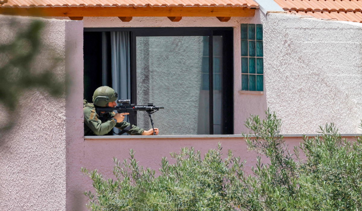 This picture taken from a position in northern Israel on the border with southern Leabanon shows an Israeli soldier taking position on the balcony of a building on May 31, 2026. (AFP)