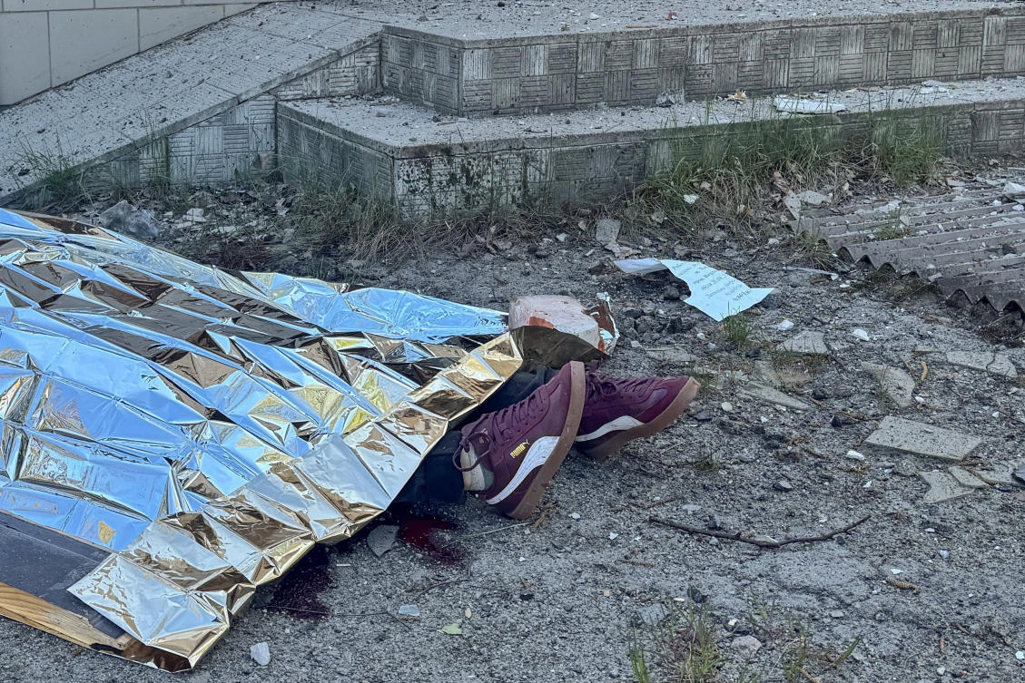 The body of a killed resident lays on the ground at the site of a Russian missile strike in the town of Merefa, amid Russia's attack on Ukraine, in the Kharkiv region, Ukraine May 4, 2026. (REUTERS)