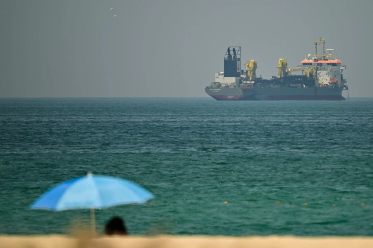A commercial vessel is seen off the coast of Dubai, UAE, Apr. 20, 2026. (Files / AFP)