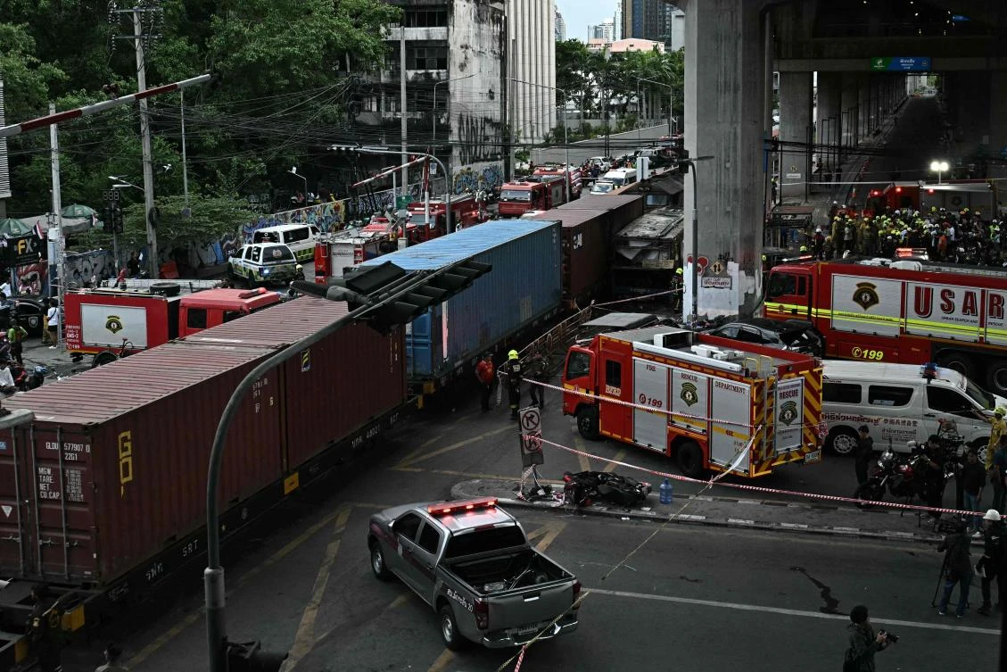 The freight train crashed into the public bus on Saturday afternoon at a busy junction in Bangkok, with the vehicle bursting into flames and 30 people left injured. (AFP)