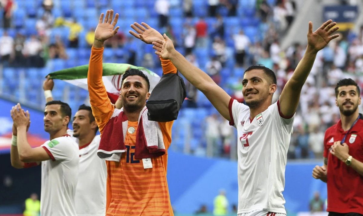 Iran's goalkeeper Rashid Mazaheri and Iran's defender Majid Hosseini celebrate after the final whistle of the Russia 2018 World Cup Group B football match between Morocco and Iran at the Saint Petersburg Stadium in Saint Petersburg on June 15, 2018. (AFP)