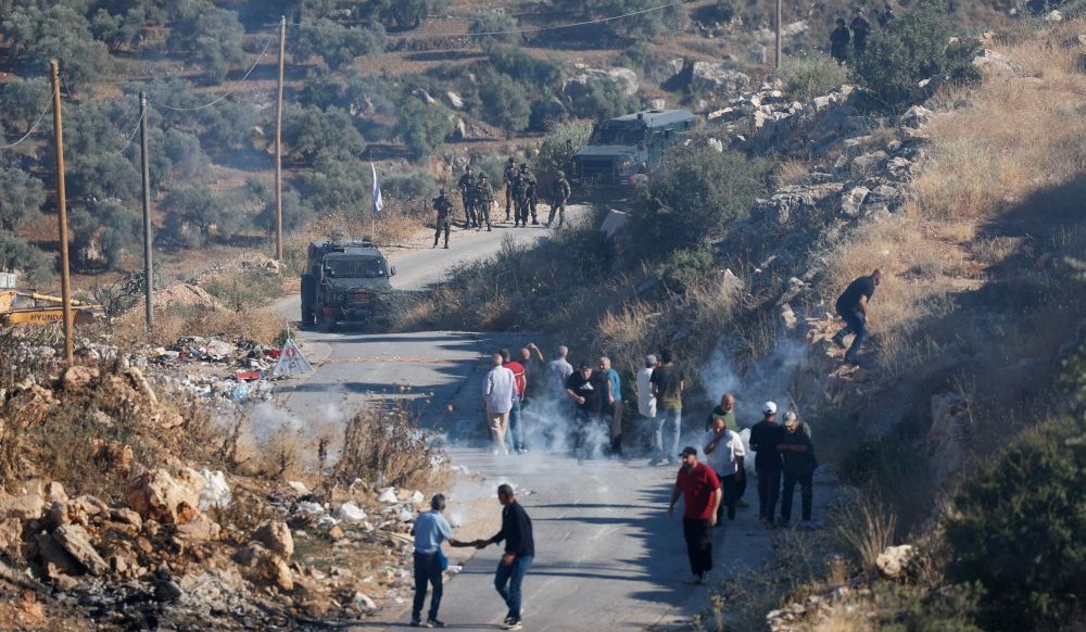 Israeli soldiers fire tear gas during a protest against a new Israeli settlement, Deir Abu Mishal, June 13, 2026. (Reuters)