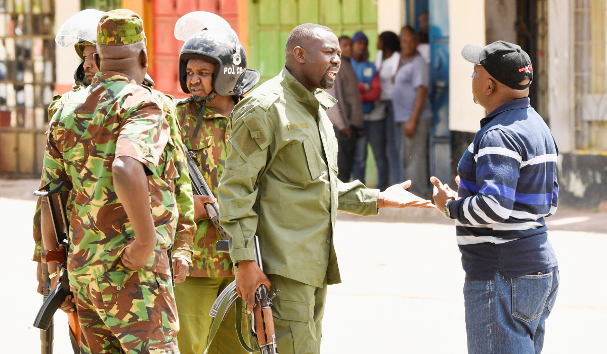 Riot police officers talk to a demonstrator during protests against a U.S.-backed Ebola quarantine plan on the establishment of a 50-bed facility at a Kenyan air force base that was intended to host Americans exposed to Ebola, in Nanyuki town, in Laikipia County, Kenya June 1, 2026. (REUTERS)
