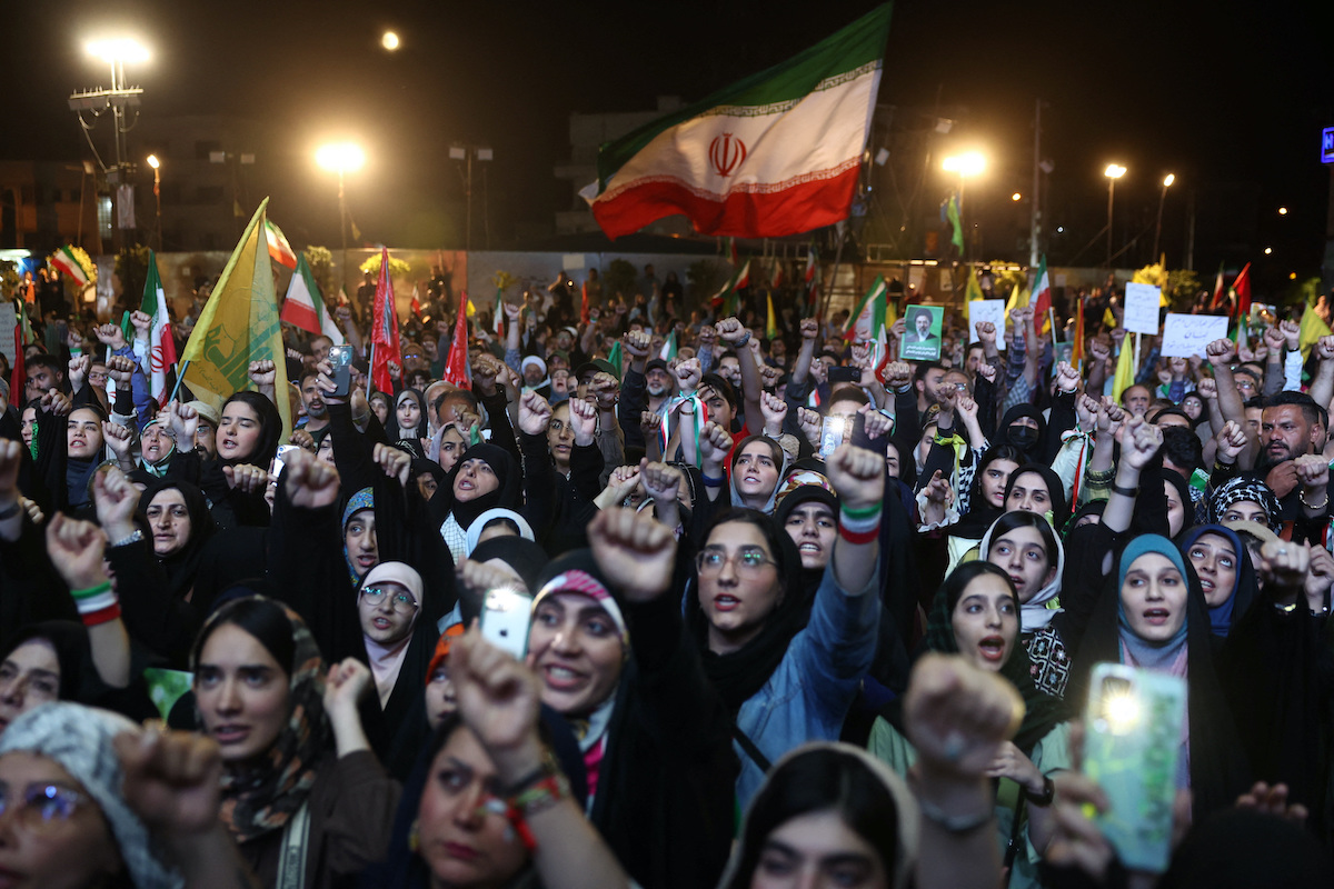People chant during a rally in Tehran on Monday night as progress toward a US-Iran peace deal faltered. (West Asia News Agency via Reuters)