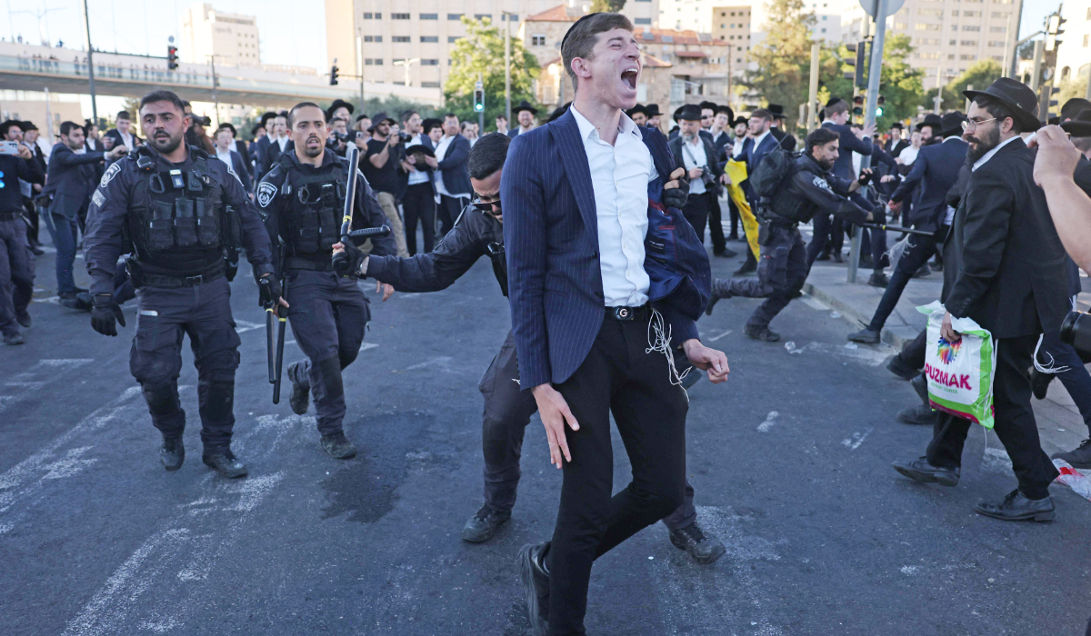 Israeli police disperse ultra-Orthodox Jews protesting against conscription by blocking the entrance to Jerusalem, on June 1, 2026. (AFP)