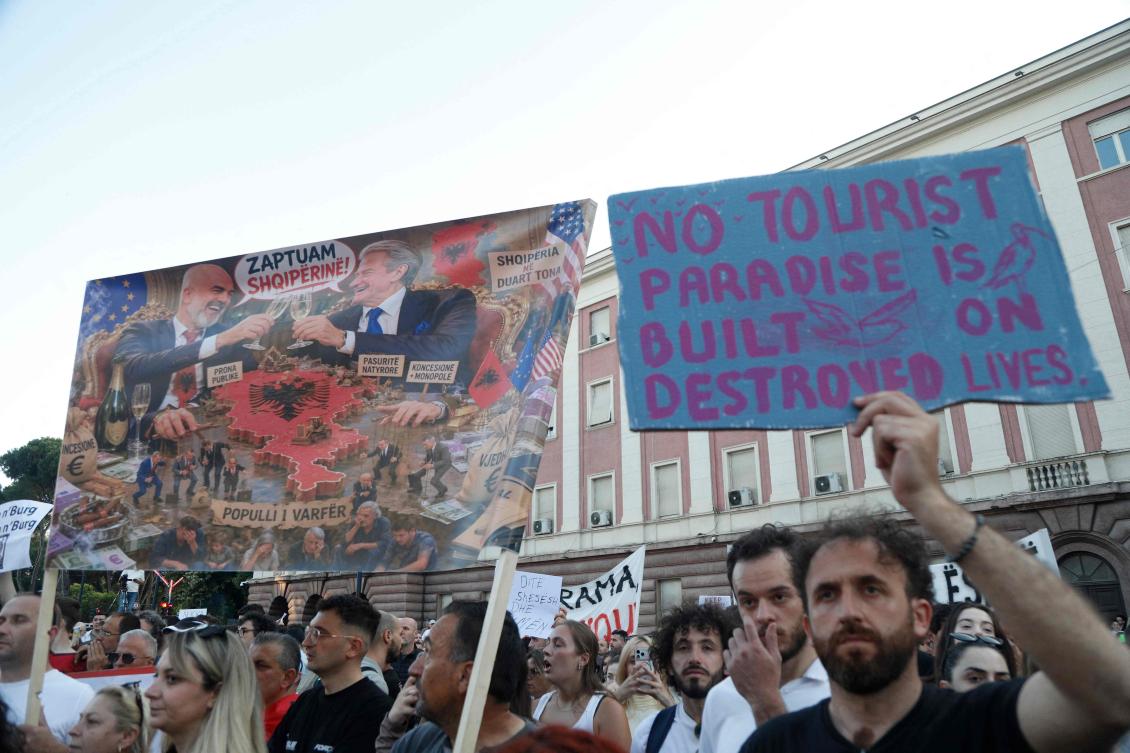 Protesters take part in a demonstration, in front of the prime minister’s office, against the construction of a luxury resort near a protected natural area, in Tirana, June 2, 2026. (AFP)